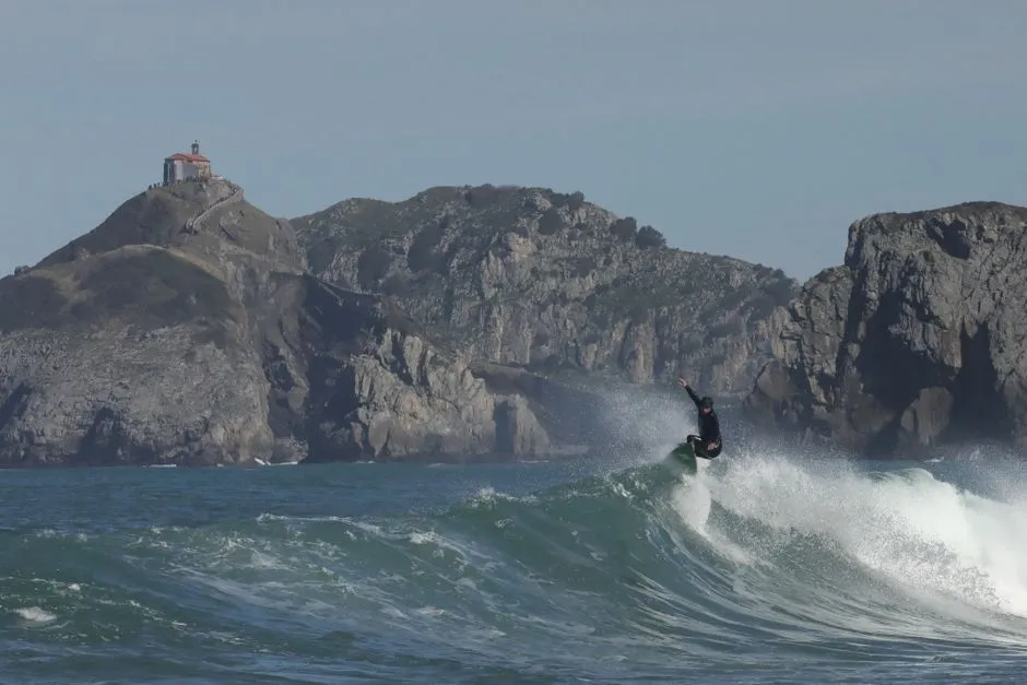 Riding a heavy one with Gaztelugatxe behind
