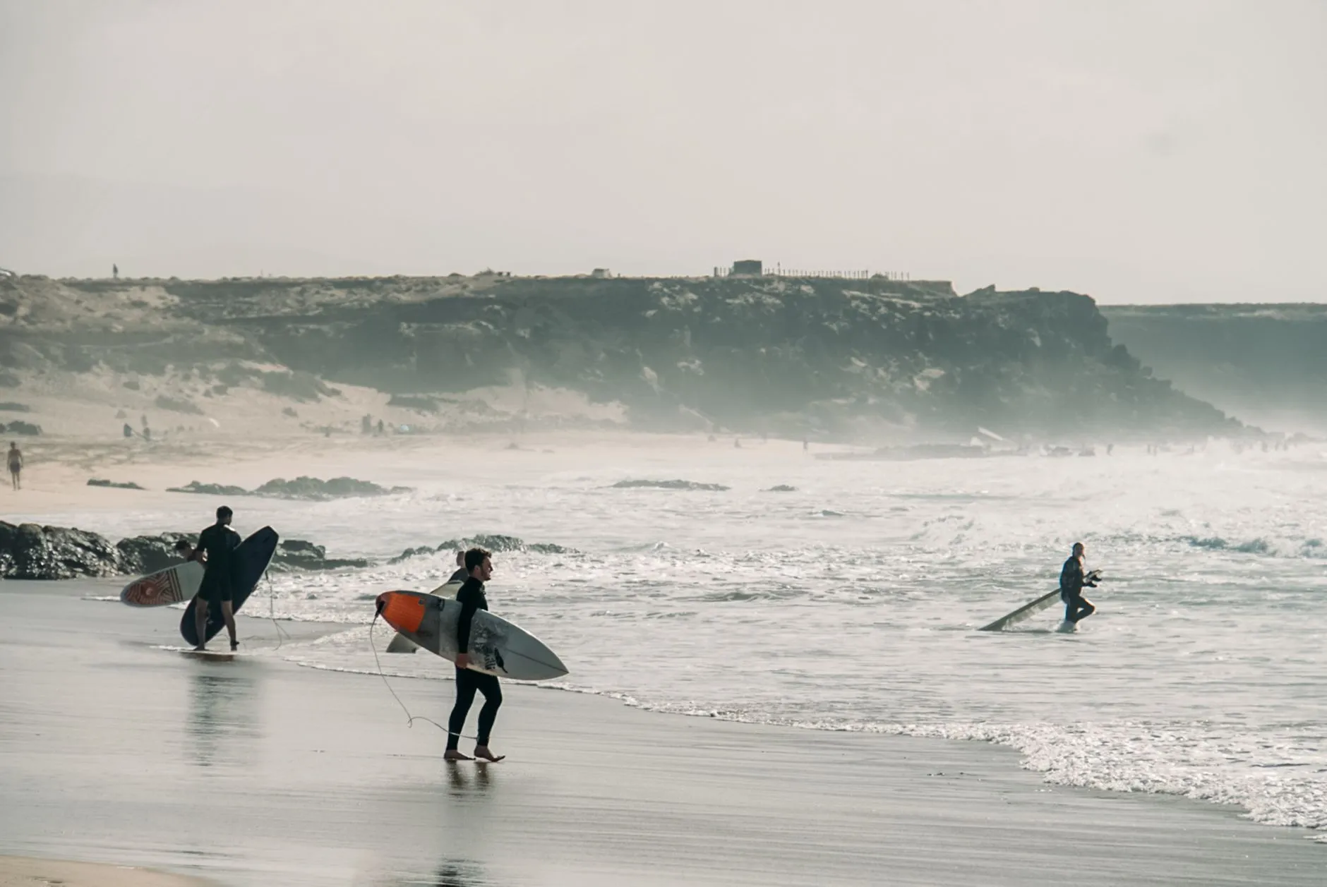 Surfers heading out at El Cotillo