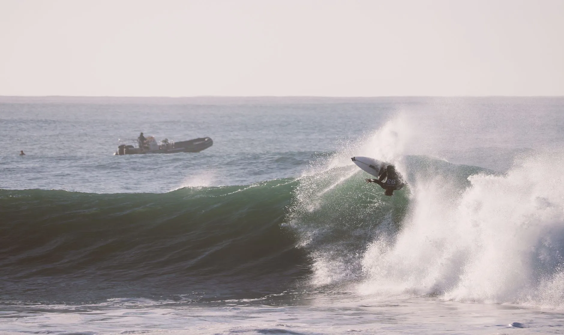 Contest day at Supertubes, the water patrol idling behind the peak