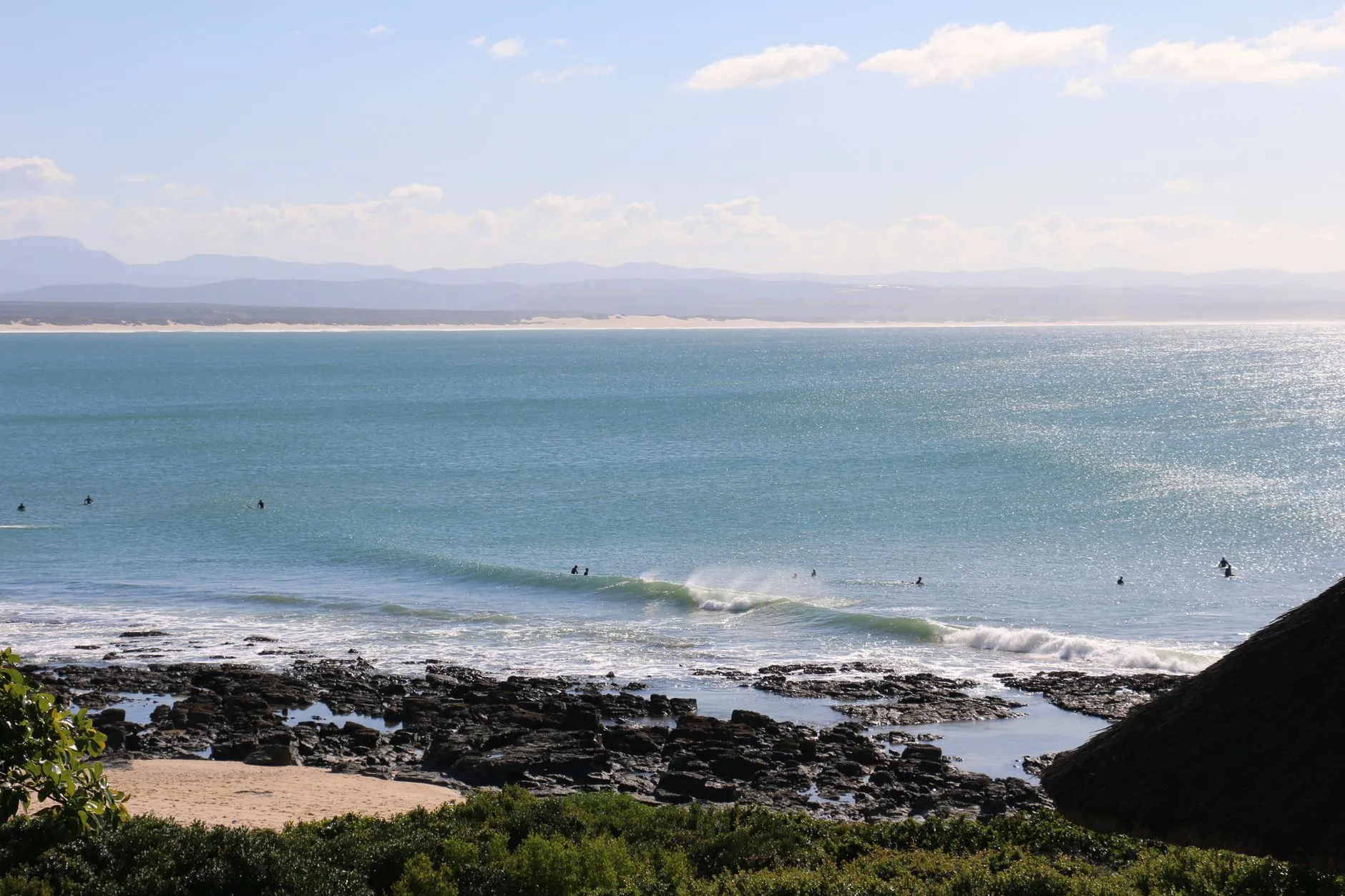 Looking down the point at Jeffreys Bay on a small, clean day, the Kouga mountains behind