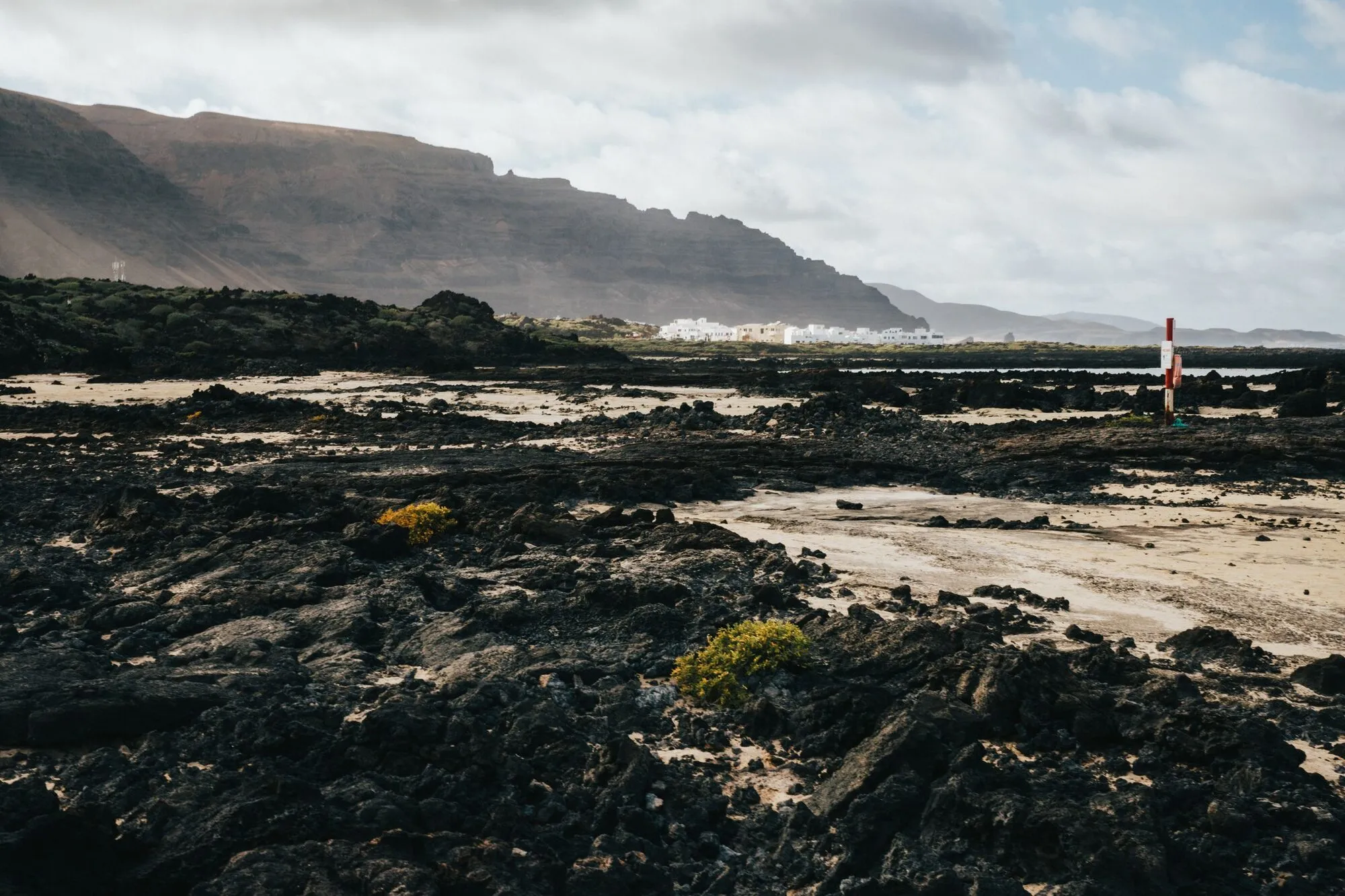 Caleta de Famara from the lava shore, the Risco behind