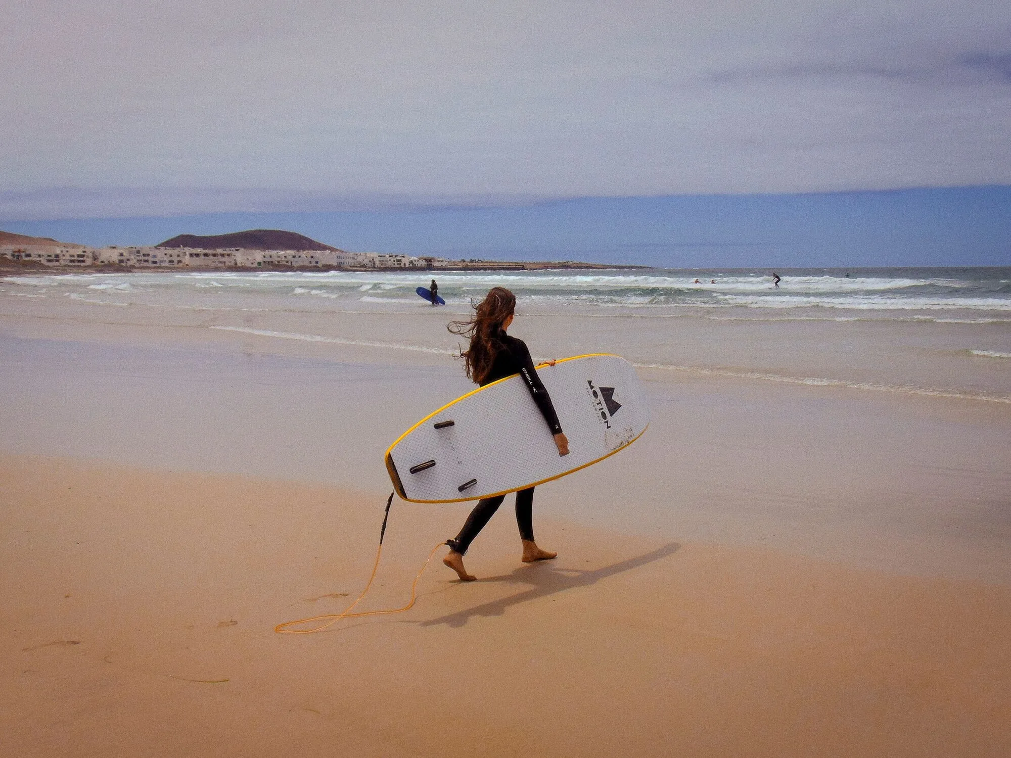 Walking back up the sand at Caleta de Famara