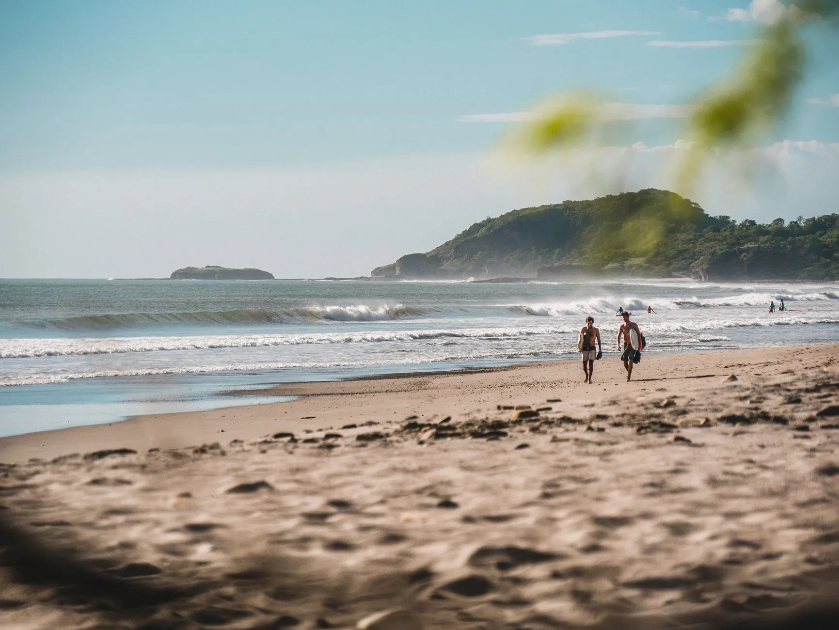 Boards under arm, two surfers on the walk to the morning check