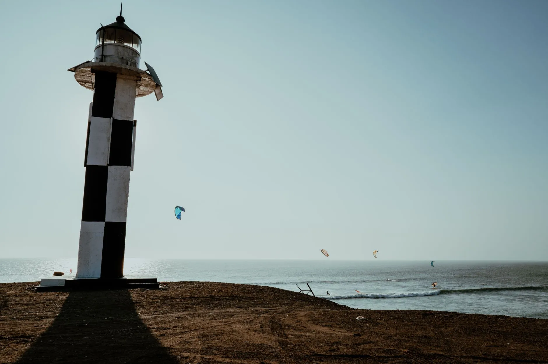 The lighthouse at Pacasmayo, kitesurfers riding the wind that never stops