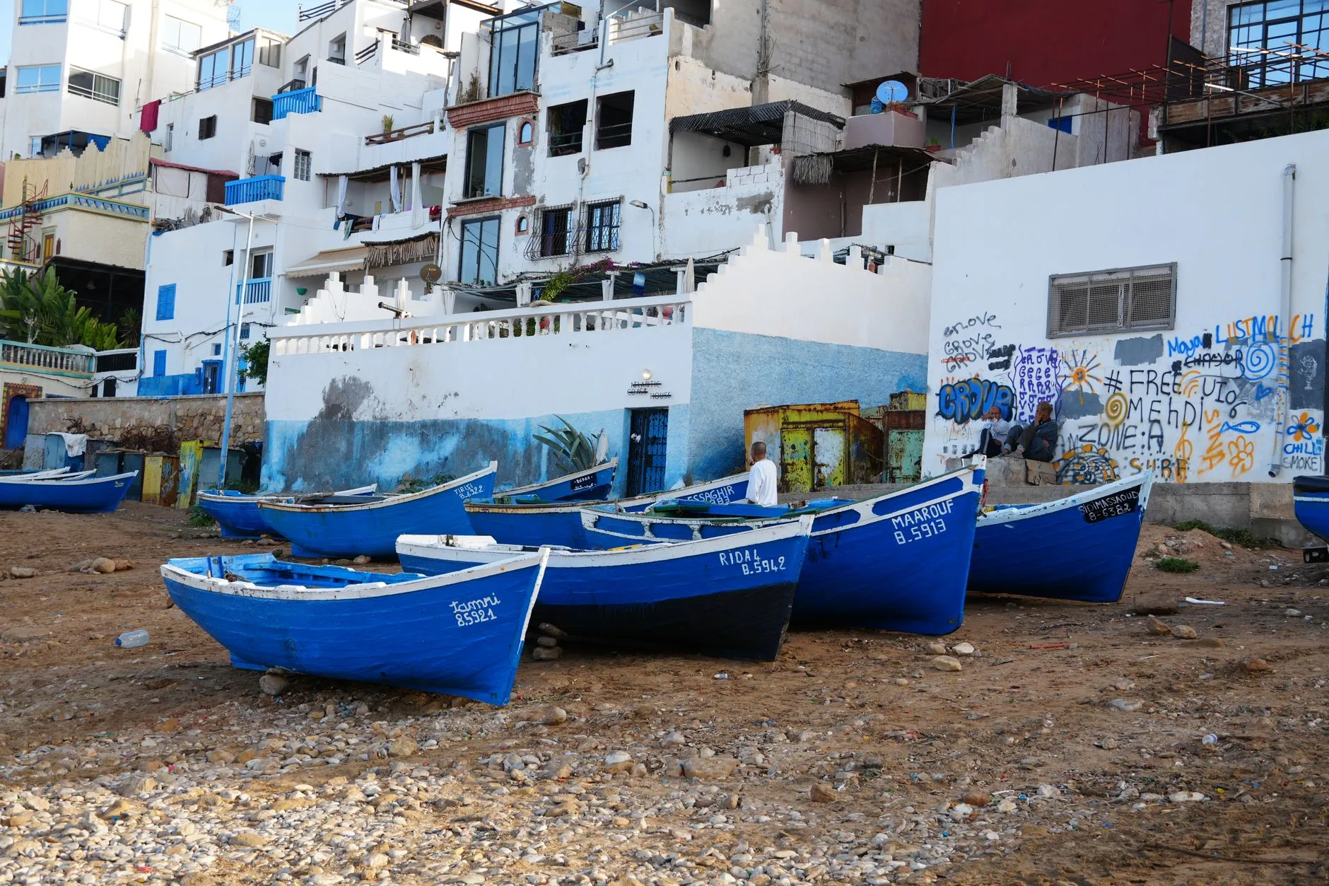 Taghazout, blue boats and flat roofs above the points